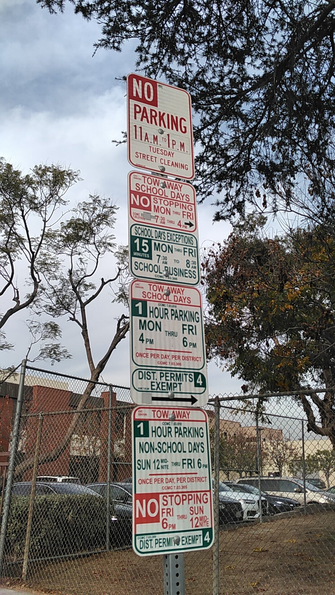 A tall stack of overlapping parking restriction signs — the kind Park-It decodes instantly